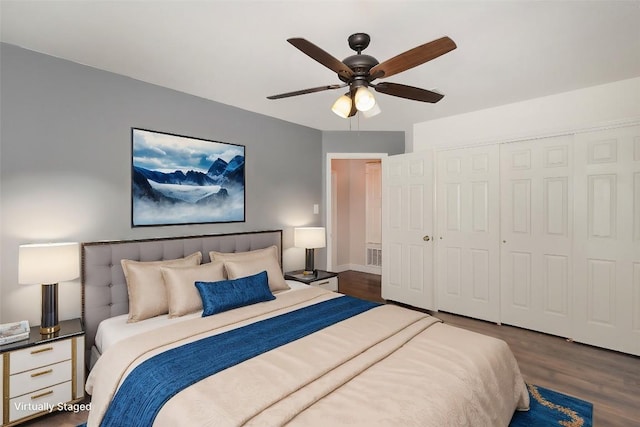 bedroom featuring dark hardwood / wood-style flooring, a closet, and ceiling fan