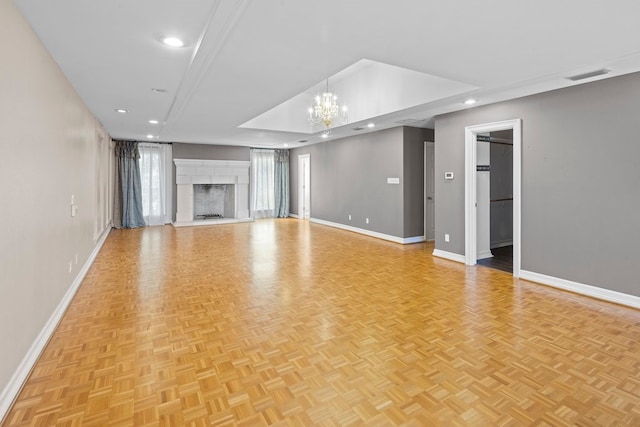 unfurnished living room with a chandelier and light parquet floors