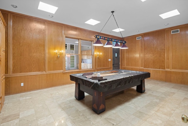 game room with pool table and wooden walls