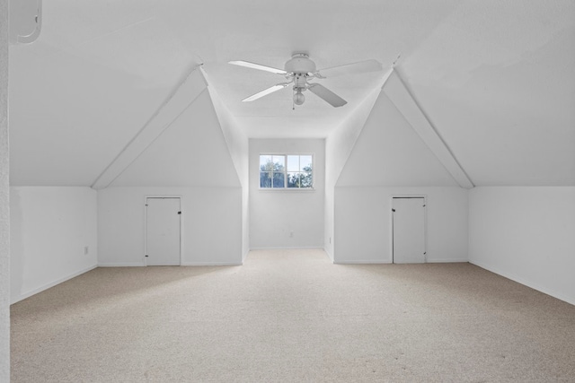 additional living space featuring carpet, ceiling fan, and lofted ceiling