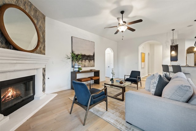 living room with ceiling fan and light wood-type flooring