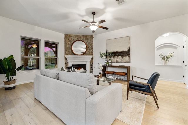 living room with ceiling fan and light hardwood / wood-style floors