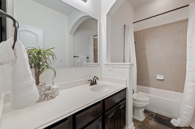 full bathroom with vanity, shower / tub combo, and toilet