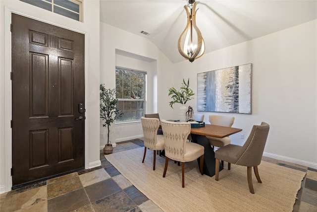 dining room featuring a chandelier and vaulted ceiling