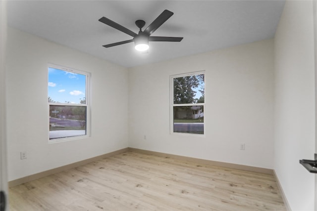 empty room featuring light hardwood / wood-style flooring and ceiling fan