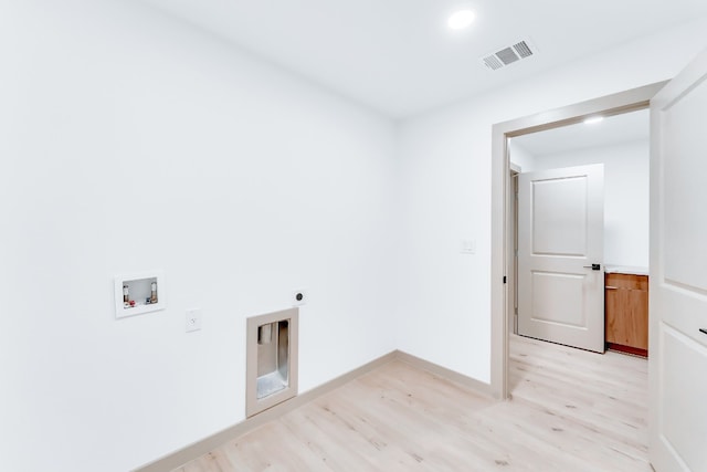 clothes washing area with washer hookup, light hardwood / wood-style floors, and electric dryer hookup