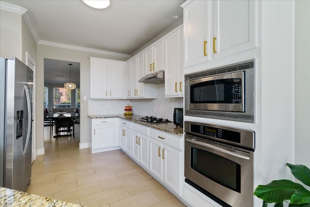 kitchen featuring white cabinetry, stainless steel appliances, tasteful backsplash, and dark stone countertops