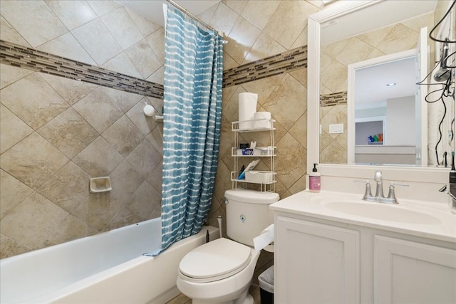 full bathroom featuring shower / bath combo, tile walls, vanity, and toilet