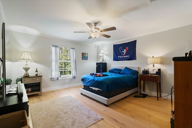 bedroom with ceiling fan, ornamental molding, and wood-type flooring