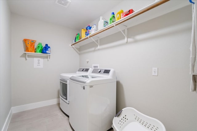 laundry room featuring washing machine and clothes dryer