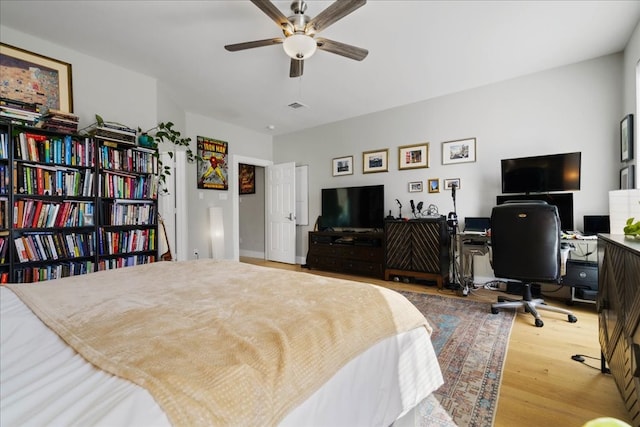 bedroom with hardwood / wood-style floors and ceiling fan