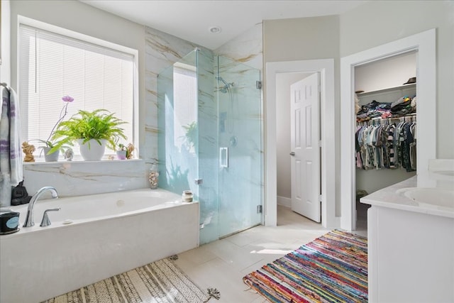 bathroom with plus walk in shower, vanity, and tile patterned floors