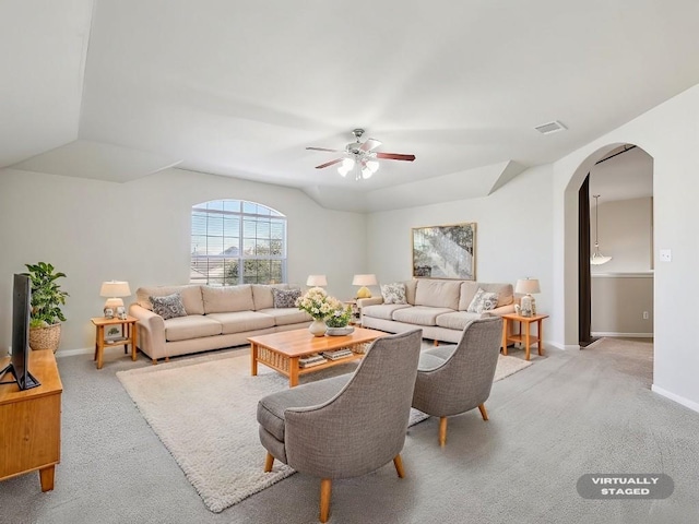 living room with vaulted ceiling, light colored carpet, and ceiling fan