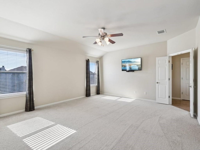 interior space with ceiling fan, light colored carpet, and lofted ceiling