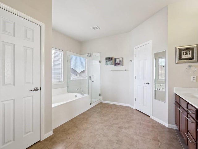 bathroom with tile patterned flooring, vanity, and separate shower and tub