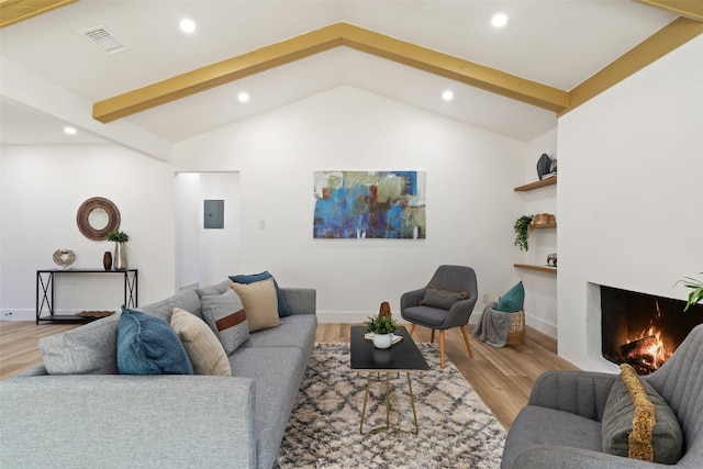 living room featuring wood-type flooring, lofted ceiling with beams, and electric panel