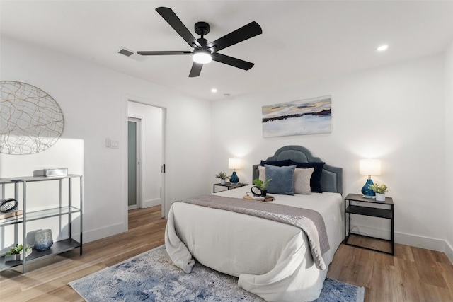 bedroom with ceiling fan and light wood-type flooring