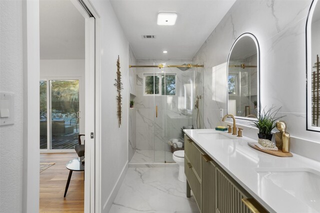 bathroom with vanity, toilet, wood-type flooring, and a shower with shower door