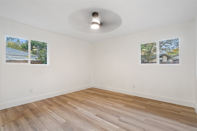 unfurnished room featuring ceiling fan, light hardwood / wood-style flooring, and a healthy amount of sunlight