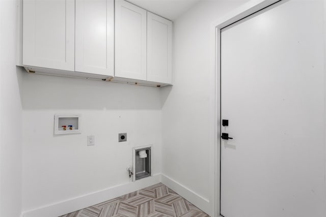 clothes washing area with cabinets, electric dryer hookup, hookup for a gas dryer, hookup for a washing machine, and light parquet floors