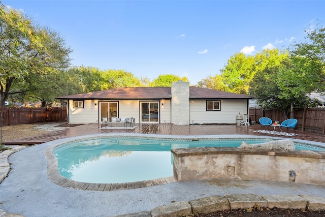 view of swimming pool featuring a wooden deck