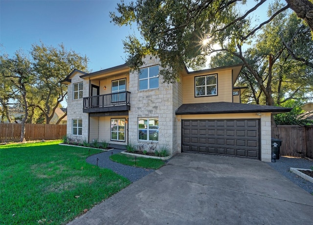 view of front facade with a balcony, a front yard, and a garage