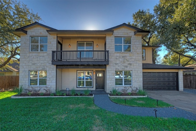 view of front of house with a front yard, a balcony, and a garage