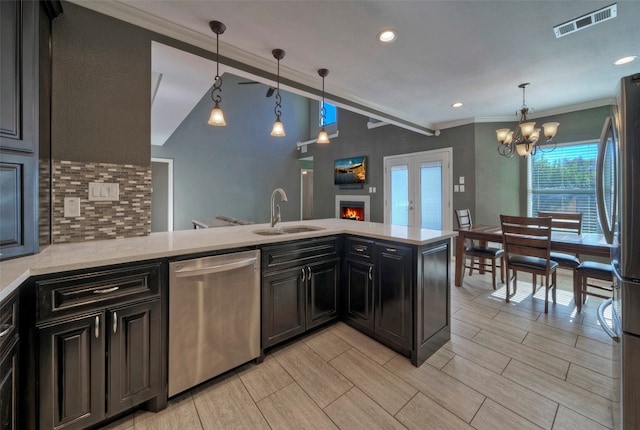 kitchen featuring kitchen peninsula, sink, hanging light fixtures, and appliances with stainless steel finishes