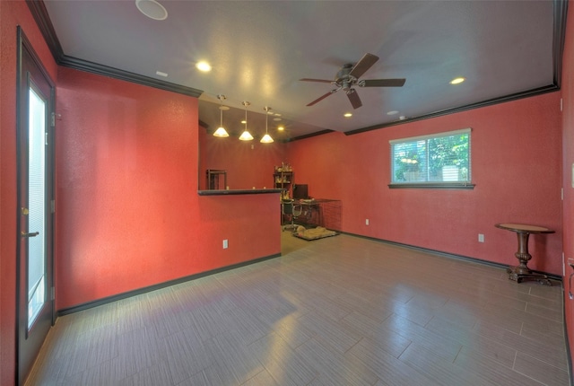 unfurnished living room with ceiling fan and ornamental molding