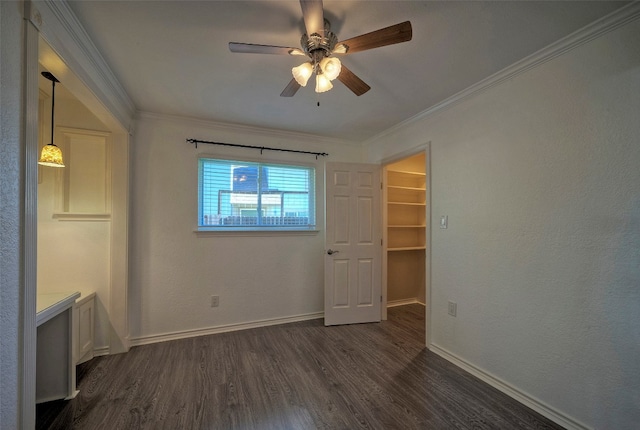 spare room featuring crown molding, dark hardwood / wood-style flooring, and ceiling fan