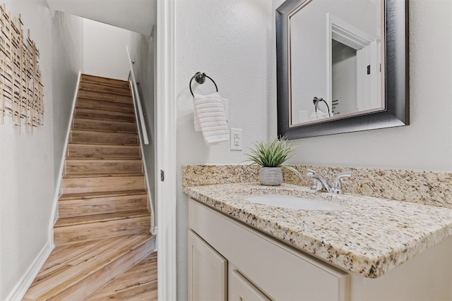 bathroom featuring hardwood / wood-style floors and vanity