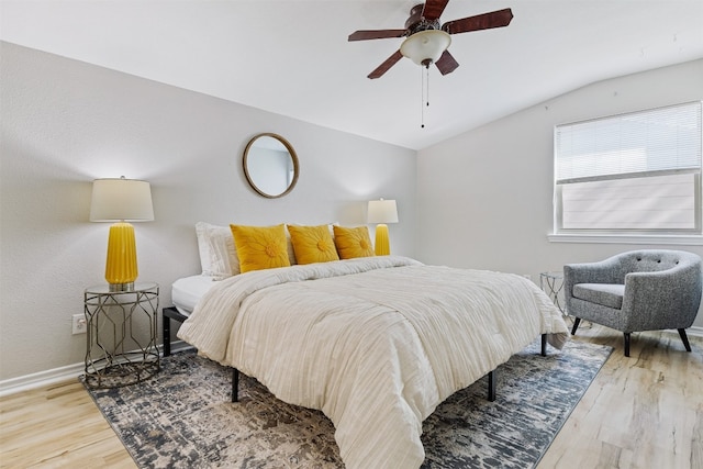 bedroom with ceiling fan, wood-type flooring, and vaulted ceiling