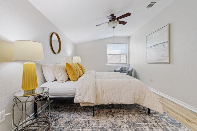 bedroom featuring ceiling fan, dark hardwood / wood-style floors, and lofted ceiling