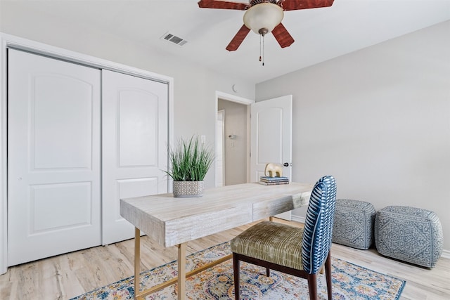 office space with light hardwood / wood-style floors and ceiling fan