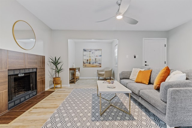 living room featuring light wood-type flooring and ceiling fan