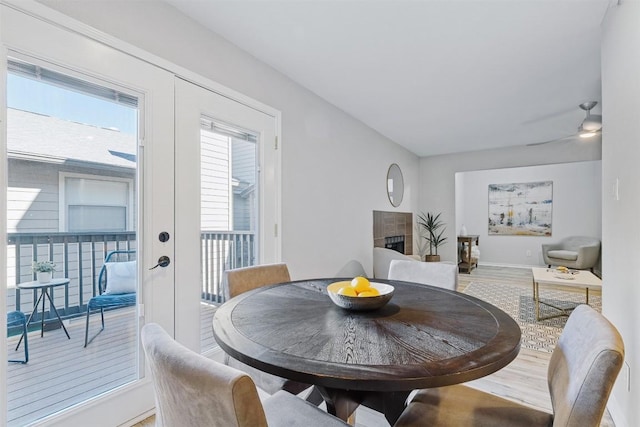 6700 Cooper Ln Unit 9, Austin, TX 78745 - dining room with wood finished floors, french doors, a ceiling fan, and a fireplace