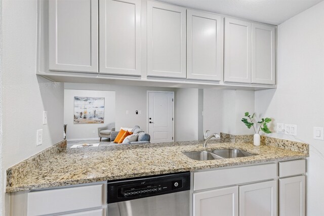 kitchen with dishwasher, light stone counters, white cabinetry, and sink