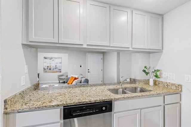 6700 Cooper Ln Unit 9, Austin, TX 78745 - kitchen featuring stainless steel dishwasher, white cabinetry, light stone counters, open floor plan, and a peninsula