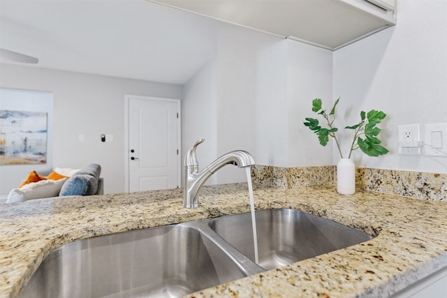 kitchen with light stone countertops and sink