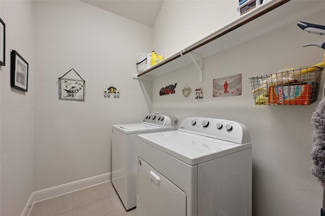 laundry room with washer and clothes dryer and light tile patterned floors