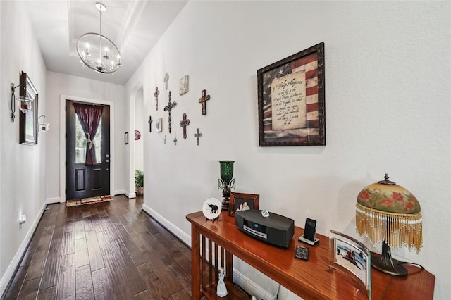 entrance foyer featuring dark hardwood / wood-style flooring and an inviting chandelier