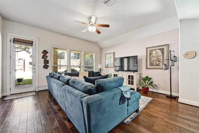 living room featuring dark hardwood / wood-style floors, ceiling fan, and vaulted ceiling