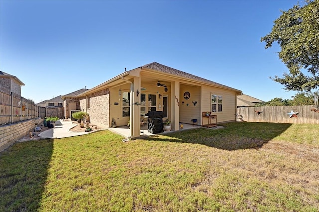 back of house featuring a lawn, a patio area, and ceiling fan