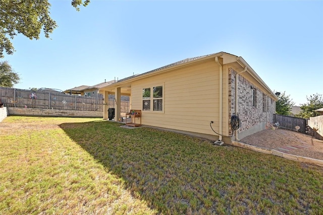 rear view of house featuring a yard