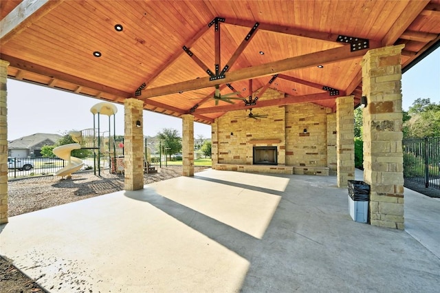 view of patio / terrace with an outdoor stone fireplace, ceiling fan, and a gazebo