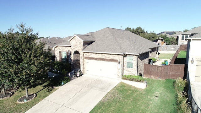 view of front of house featuring a front lawn and a garage