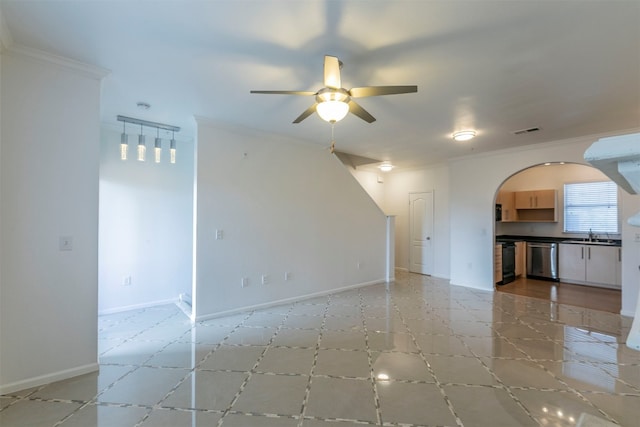 unfurnished living room featuring ceiling fan, ornamental molding, and sink