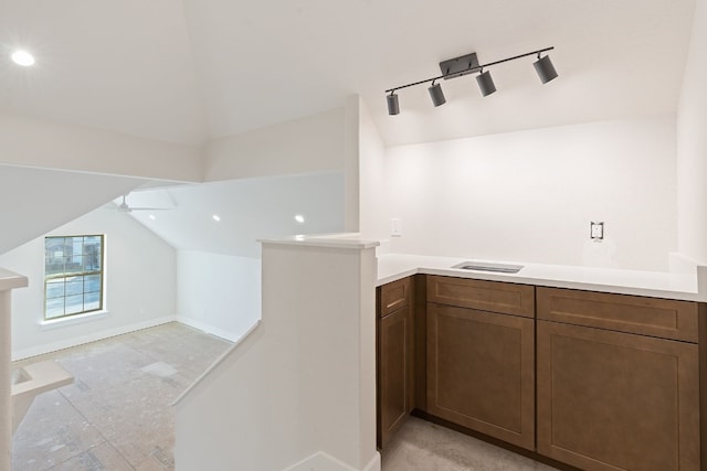 interior space featuring lofted ceiling, track lighting, and ceiling fan