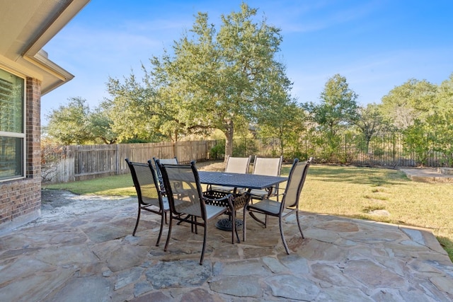 view of patio with outdoor dining space and a fenced backyard