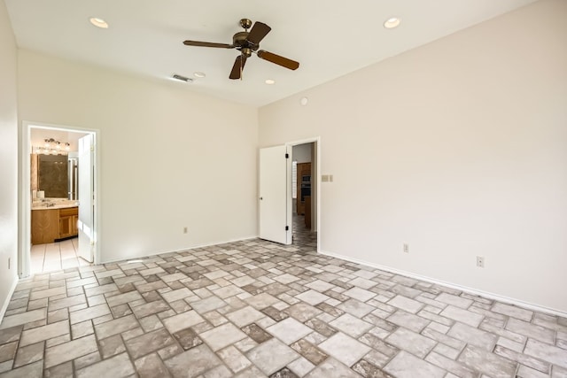 unfurnished bedroom featuring connected bathroom and ceiling fan